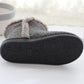 Bottom view of men's high-top slippers in dark gray with textured rubber outsole