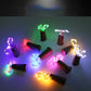 Multicolor LED wine bottle cork lights with glowing bulb loops on clear wire