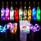Set of LED wine bottle cork lights with glowing bottle colors and clear wire loops