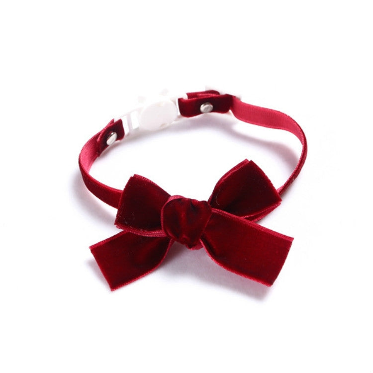 Velvet pet collar with red bowknot and adjustable strap, no bell.