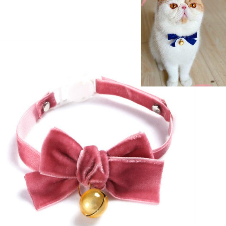 Pink velvet bow pet collar with adjustable strap and small gold bell.