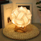 White USB bedside night light with wood base, round paper-flower shade, softly glowing