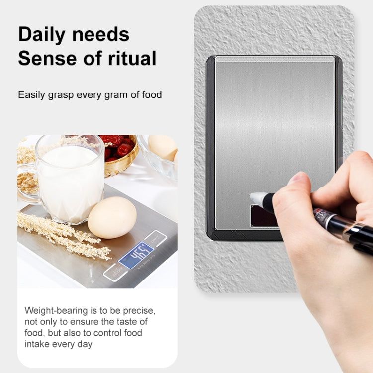 Digital kitchen scale with brushed stainless platform and hand pressing the button