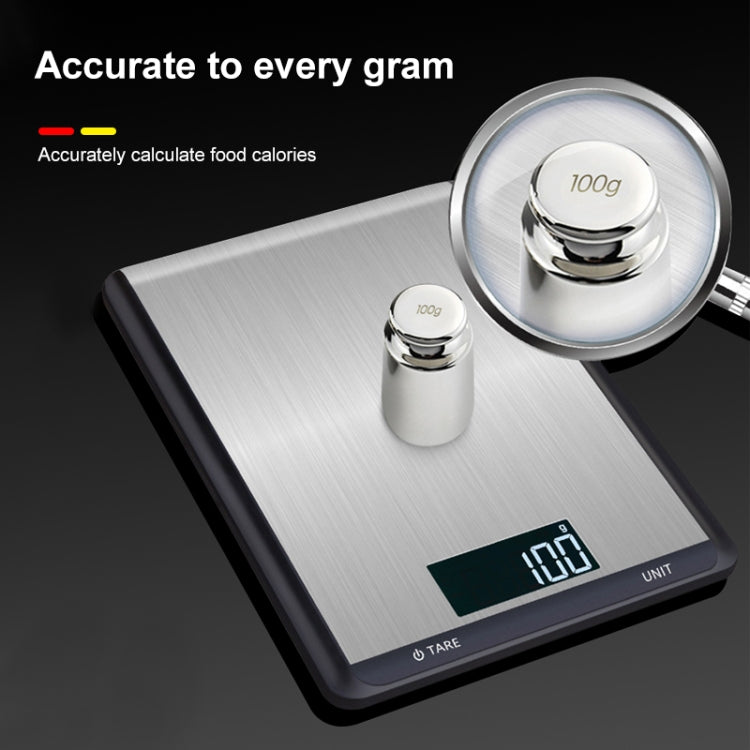 Digital kitchen scale with round metal weights on the stainless platform and LCD reading