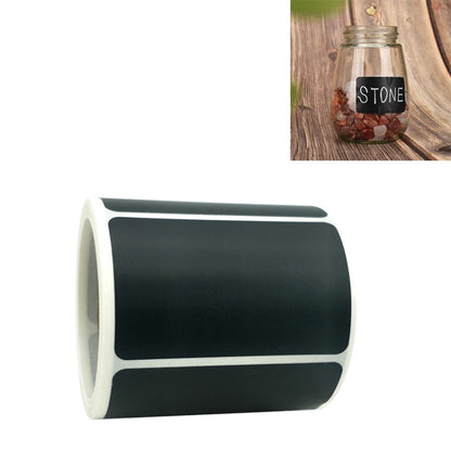 Chalkboard sticker label roll with dark gray rectangular labels on a white backing strip
