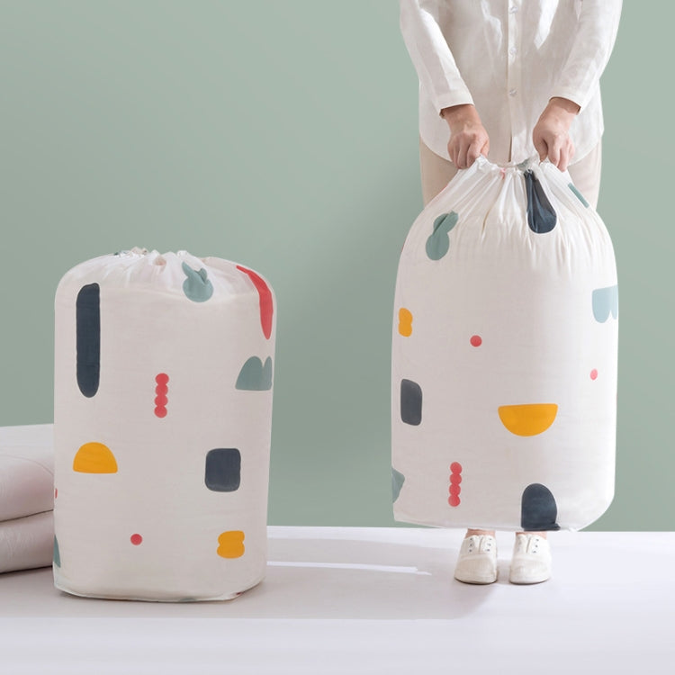 Quilt storage bags with drawstring openings, one being lifted by a person