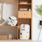 Quilt storage bag with white fabric and colorful cartoon shapes, top opening