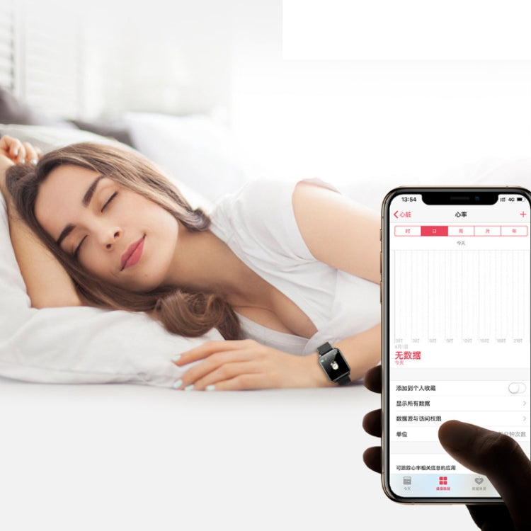 Black smart bracelet worn on wrist beside a phone during sleep