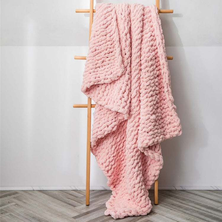 Thick knitted wool blanket, pink, draped over a stand