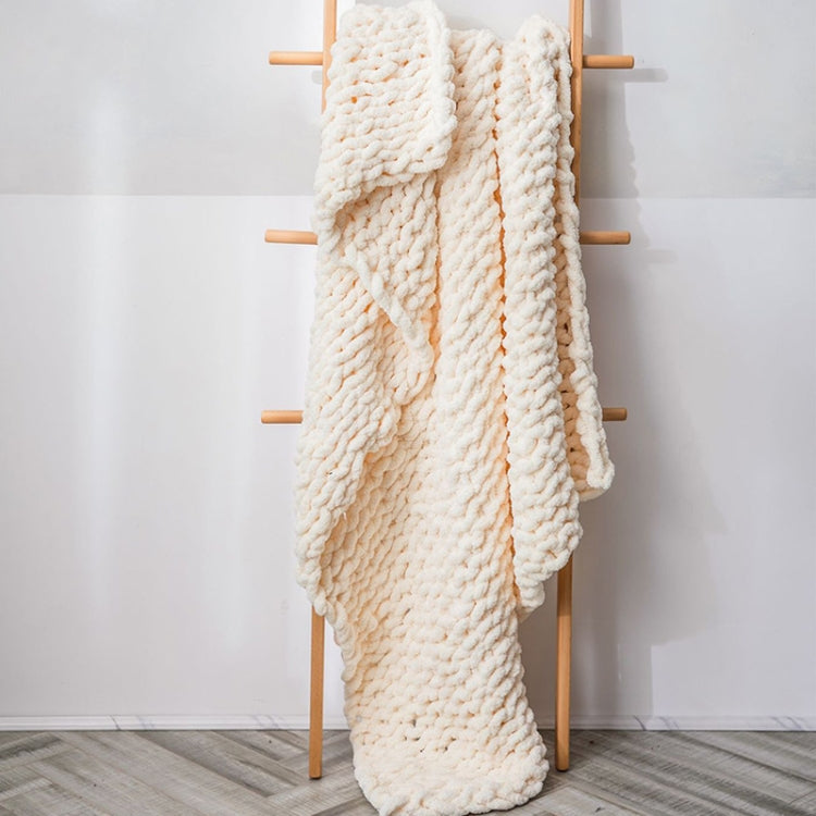 Thick knitted wool blanket, cream/ivory, draped over a stand with chunky knit