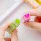 Long striped love erasers held in hands, pink heart and green star-shaped top