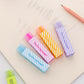Long striped love erasers scattered on paper, assorted pastel colors