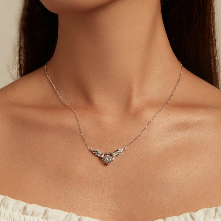Worn silver heart wing pendant necklace with round white zircon center