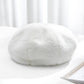 Plush women’s beret hat, white color, soft fuzzy texture.