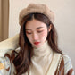 Plush beige beret hat with rounded crown and cozy fuzzy texture, adjustable fit