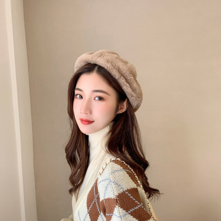 Light beige plush beret hat with soft fuzzy texture and snug, adjustable fit