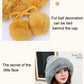 Yellow fuzzy pom-pom decorations tied behind a knit skullcap