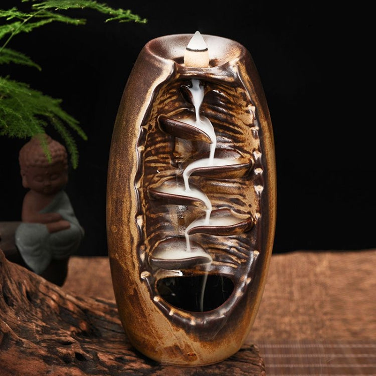 Bronze-brown ceramic incense holder with upward cone and carved backflow smoke