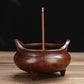 Small antique copper incense burner with central stick stand and three-toed base