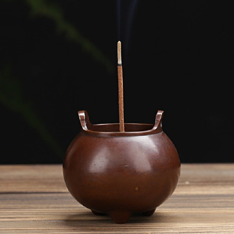 Round antique copper incense burner with upright stick holder and three legs