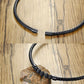 Braided black leather necklace with lava stone bead cluster and metal magnetic clasp