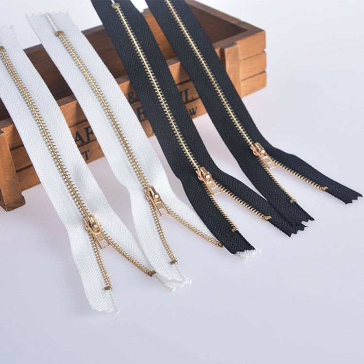 Assorted zippers: white and dark navy tapes with gold metal teeth and sliders