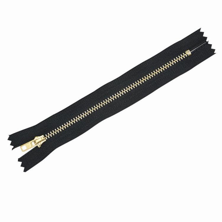 Single dark navy metal zipper with gold teeth and slider, open-end tape