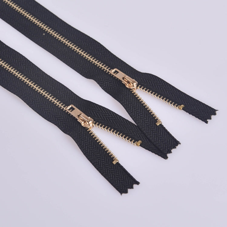 Multiple navy fabric metal zippers with light gold teeth and pulls for pants repair