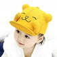 Yellow cartoon cat baby sun hat on a child, side view of embroidered face