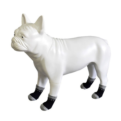 White dog wearing black and gray cotton anti-scratch socks, 4-pack