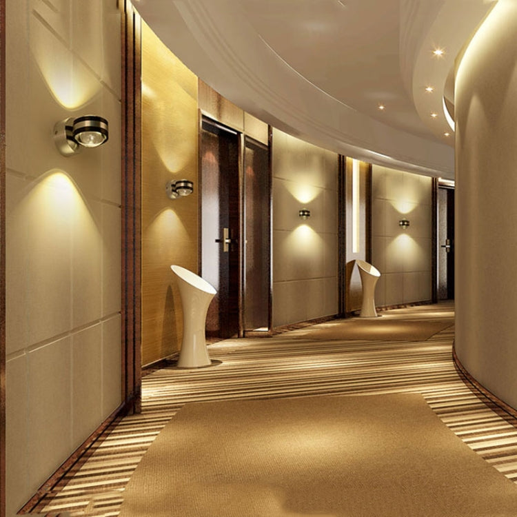 Up-down LED wall lamps along a hallway wall, warm light illumination