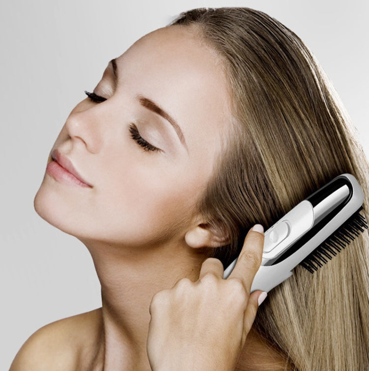 Electric massage comb brushing long hair, silver handle and black bristles