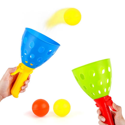Ball catapult toy set with blue and green cups and orange and yellow bouncy balls