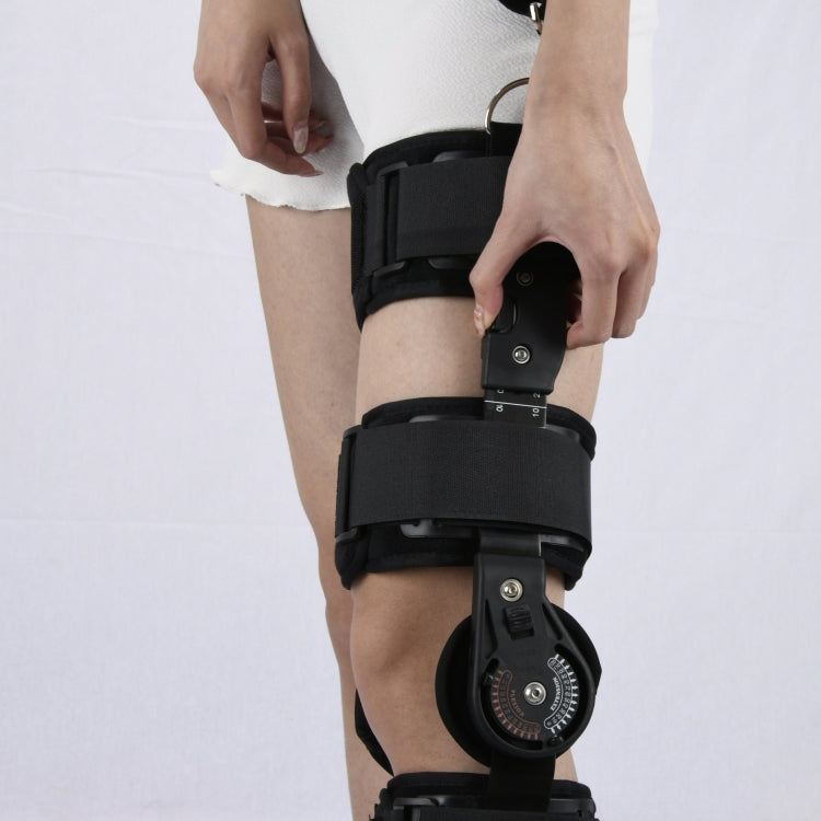 Black hinged knee fixation brace with side support bars and dial mechanism
