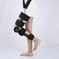 Black knee fixation brace worn on leg with adjustable straps and hinge supports
