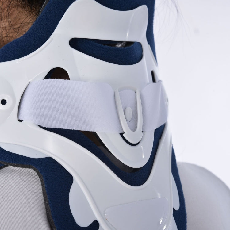 Close-up of white and navy plastic brace shell with molded openings and straps