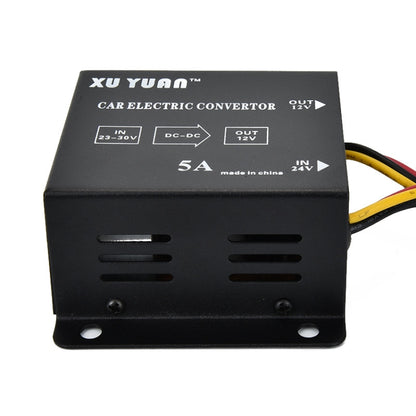 Black automotive DC step-down converter box with input/output markings and vent slots