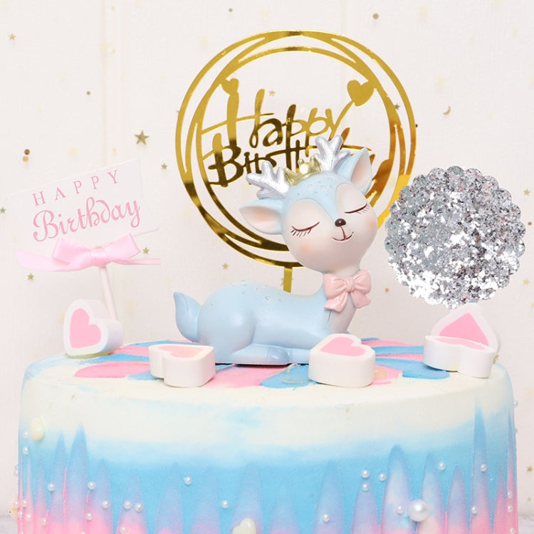 Cartoon deer resin topper on birthday cake, blue deer with antlers and bow