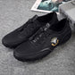 Black leather lace-up sneakers with adjustable buckles and textured tread sole