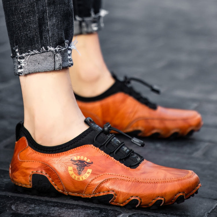 Orange leather casual sneakers with strap closure and chunky rubber tread sole