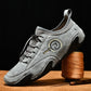 Gray leather lace-up sneakers with detailed stitching and rubber outsole tread.
