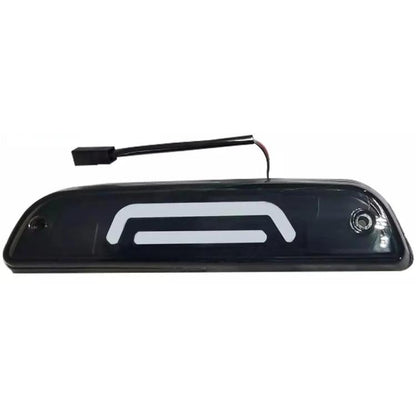 Black high-mounted brake light housing with wiring connector and white LED bar