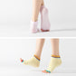 Light pink and light yellow open-toe five-finger yoga socks with dotted soles and rainbow cuffs