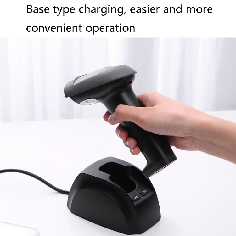 Hand holding black 1D barcode scanner over charging base with cable