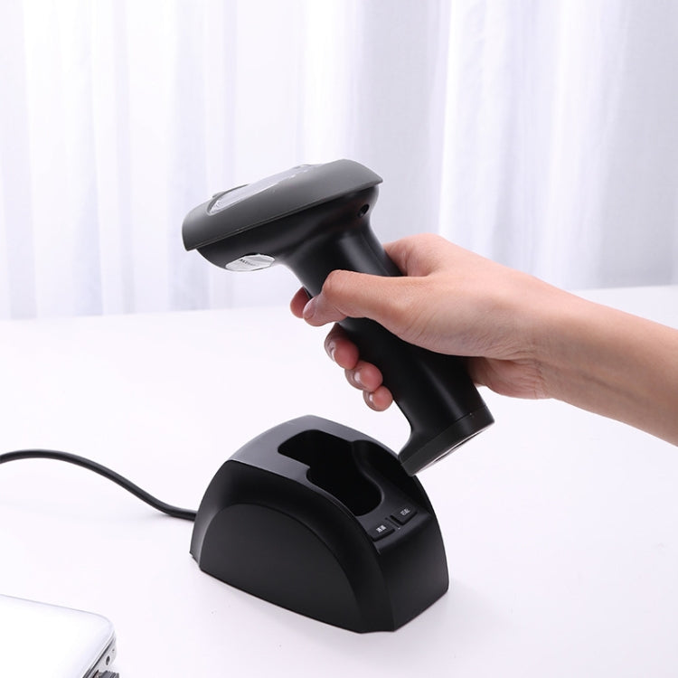 Hand using black handheld 1D barcode scanner above its stand base