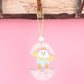 Easter wooden egg pendant with yellow chick and flowers around an egg