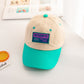 Kids baseball cap with beige crown, teal brim, and “AUTHENTIC” front patch