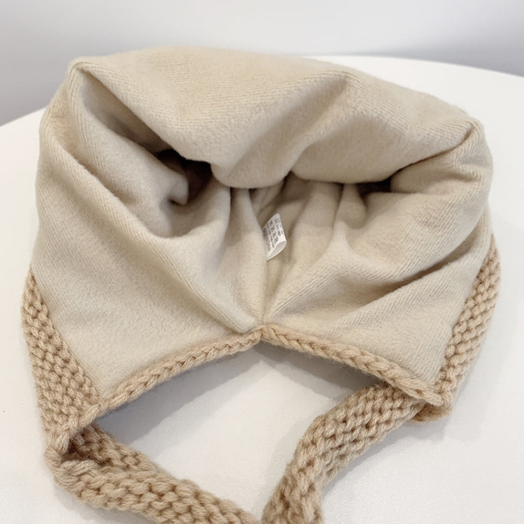 Beige knit winter hat with folded ear flaps and ribbed brim
