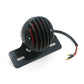 Black round tail light with red vertical LED bars on base plate and wire leads