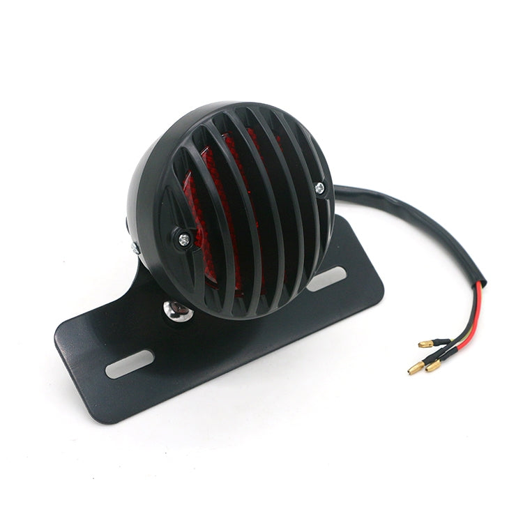 Black round tail light with red vertical LED bars on base plate and wire leads